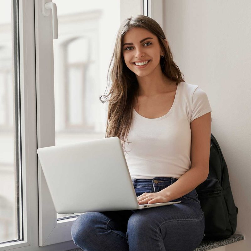 beautiful-female-student-sitting-with-laptop-on-wi-2022-01-18-23-33-22-utc.jpg