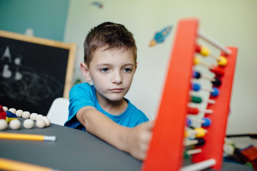 schoolboy-learning-maths-with-an-abacus-2021-08-26-20-15-04-utc.jpg