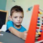 schoolboy-learning-maths-with-an-abacus-2021-08-26-20-15-04-utc.jpg